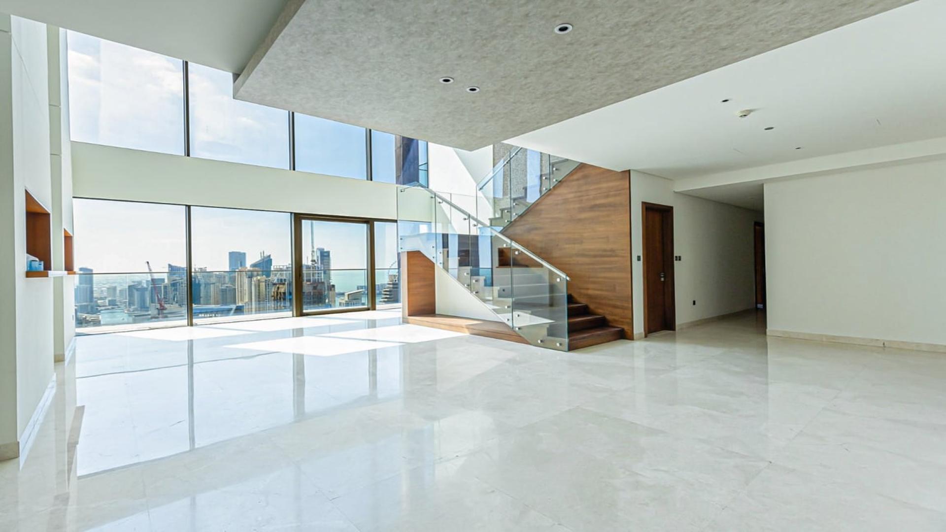 Aerial view of Dubai Marina skyline and marina, showcasing luxury yachts and skyscrapers
