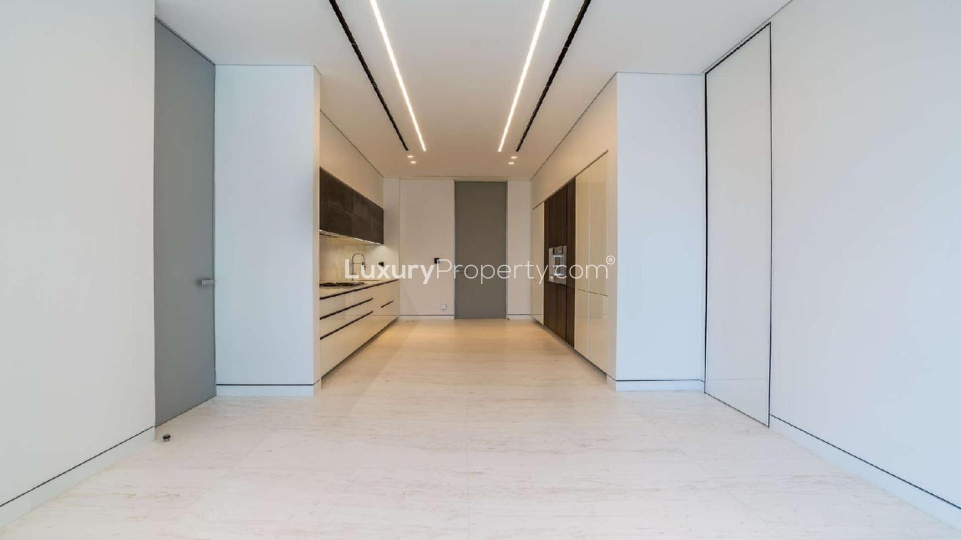 "Spacious living area with ocean views in Palme Couture apartment, Palm Jumeirah, Dubai.","Modern kitchen in four-bedroom apartment, Palme Couture, Palm Jumeirah, Dubai, for sale.",Spacious living room with ocean view in Palme Couture, Palm Jumeirah apartment for sale