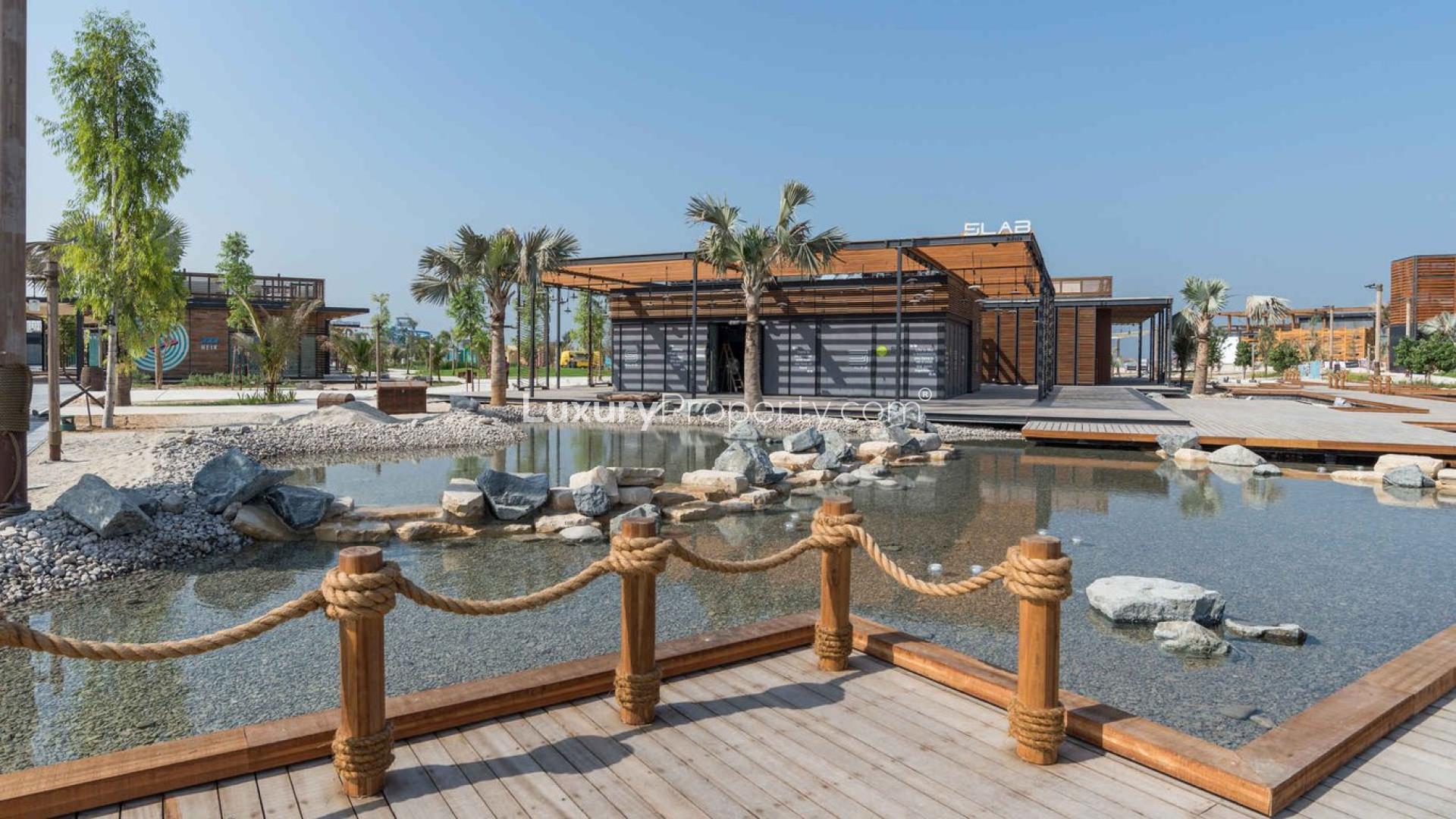 Modern kitchen in three-bed apartment, La Mer, Jumeirah, featuring sleek countertops and cabinetry