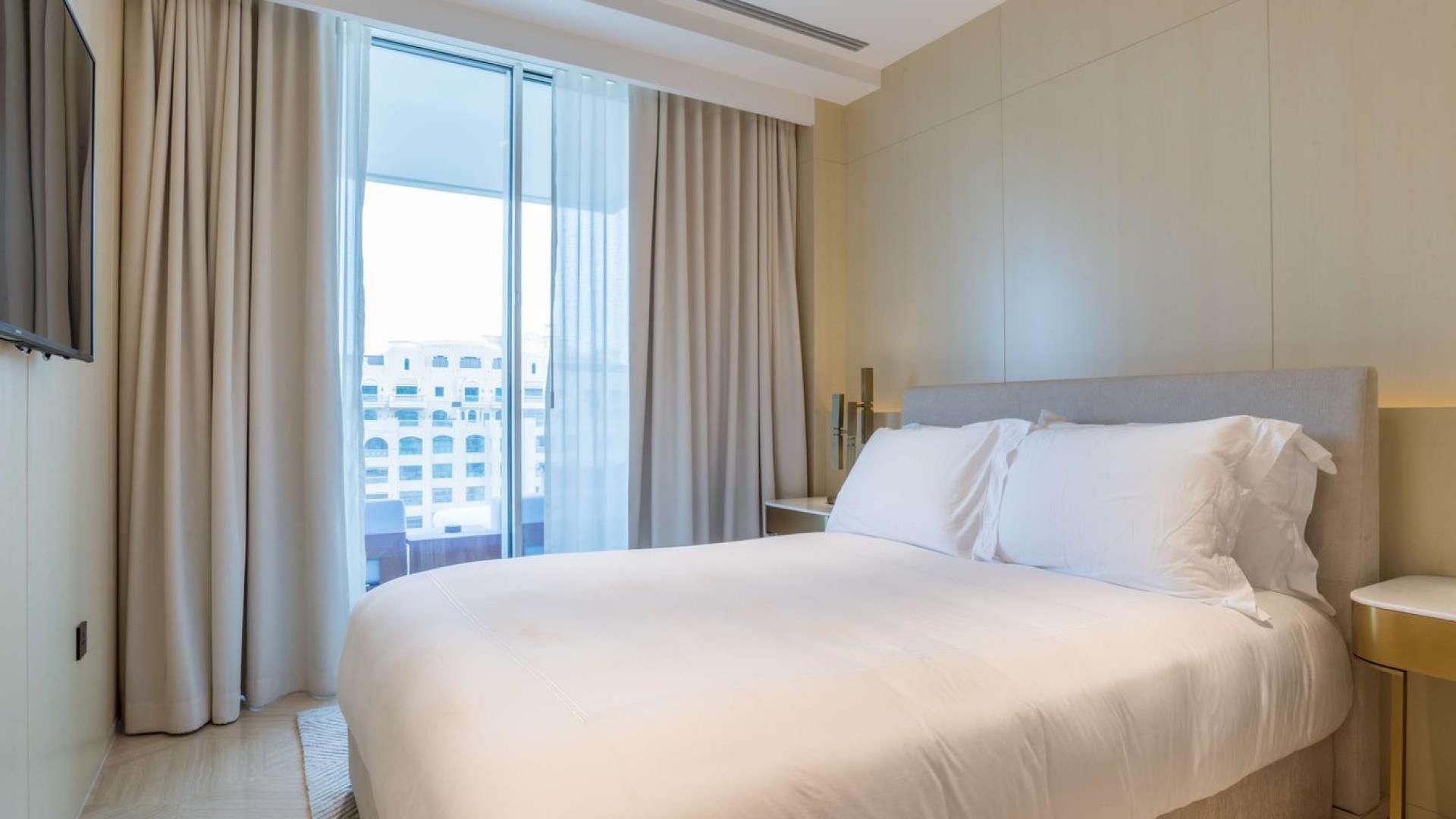 Luxurious bedroom with balcony view in serviced Palm Jumeirah apartment for sale
