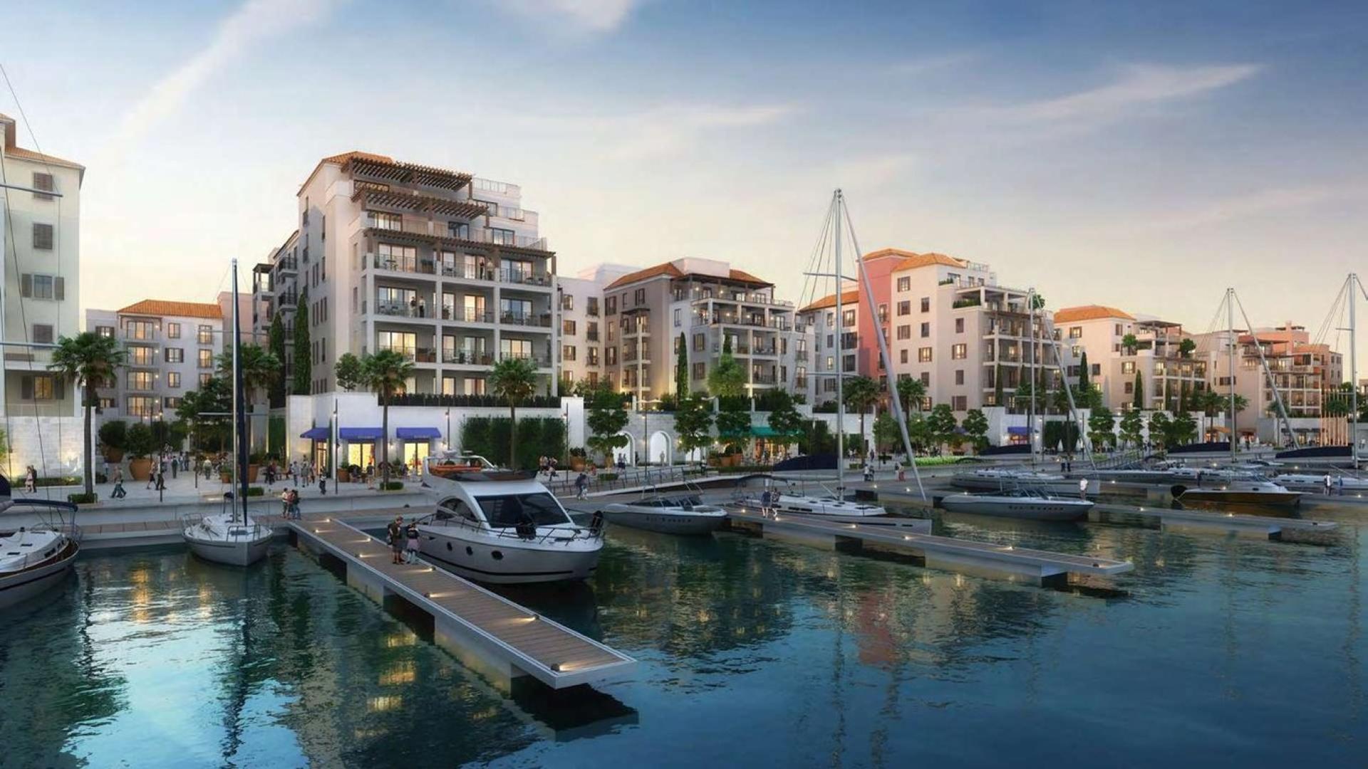 "Charming courtyard view of La Rive apartments in Jumeirah's Port De La Mer community.",La Rive apartment buildings overlooking marina in Port De La Mer, Jumeirah, Dubai