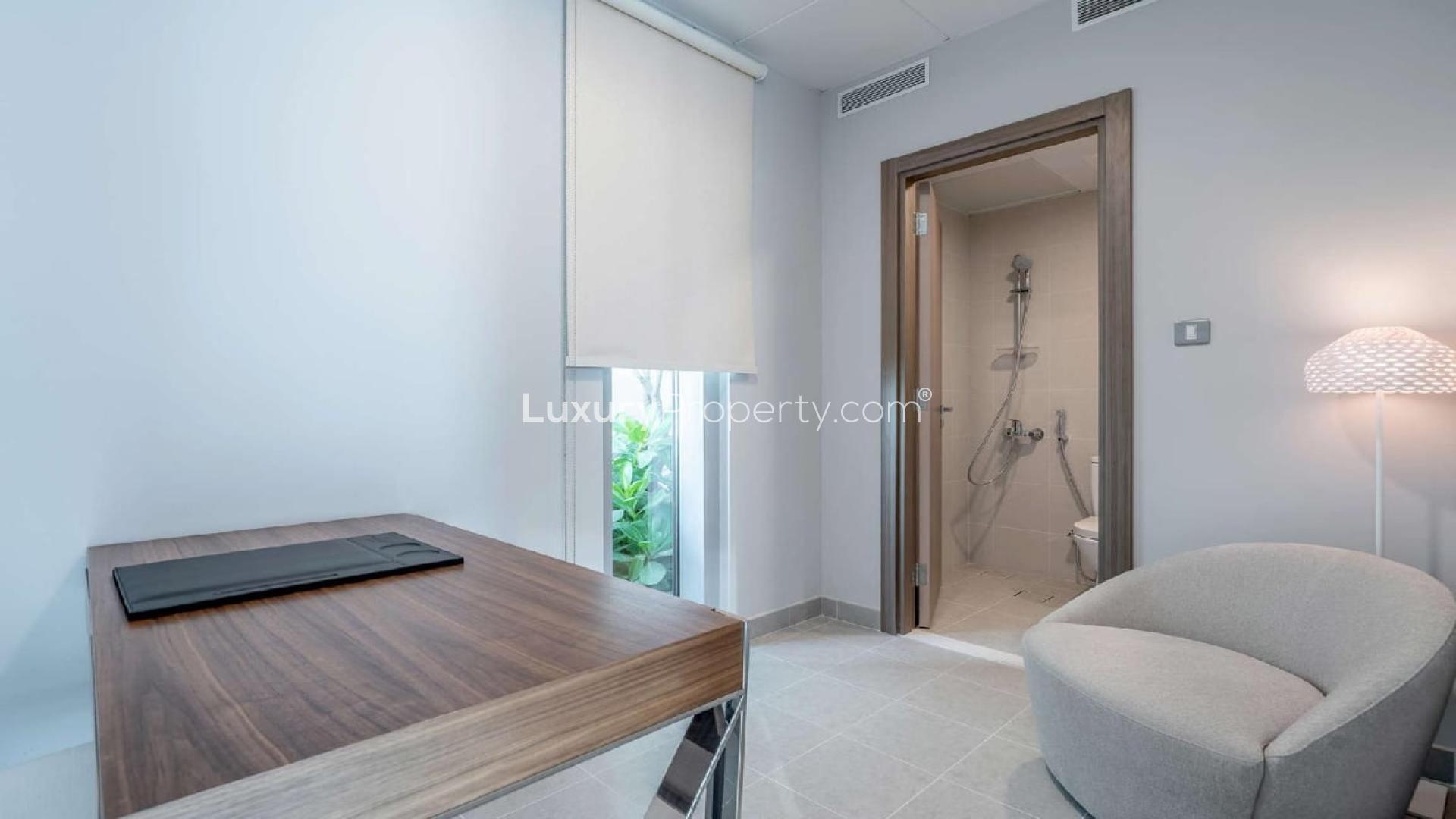 Bright living room in District One apartment, featuring modern decor and large windows