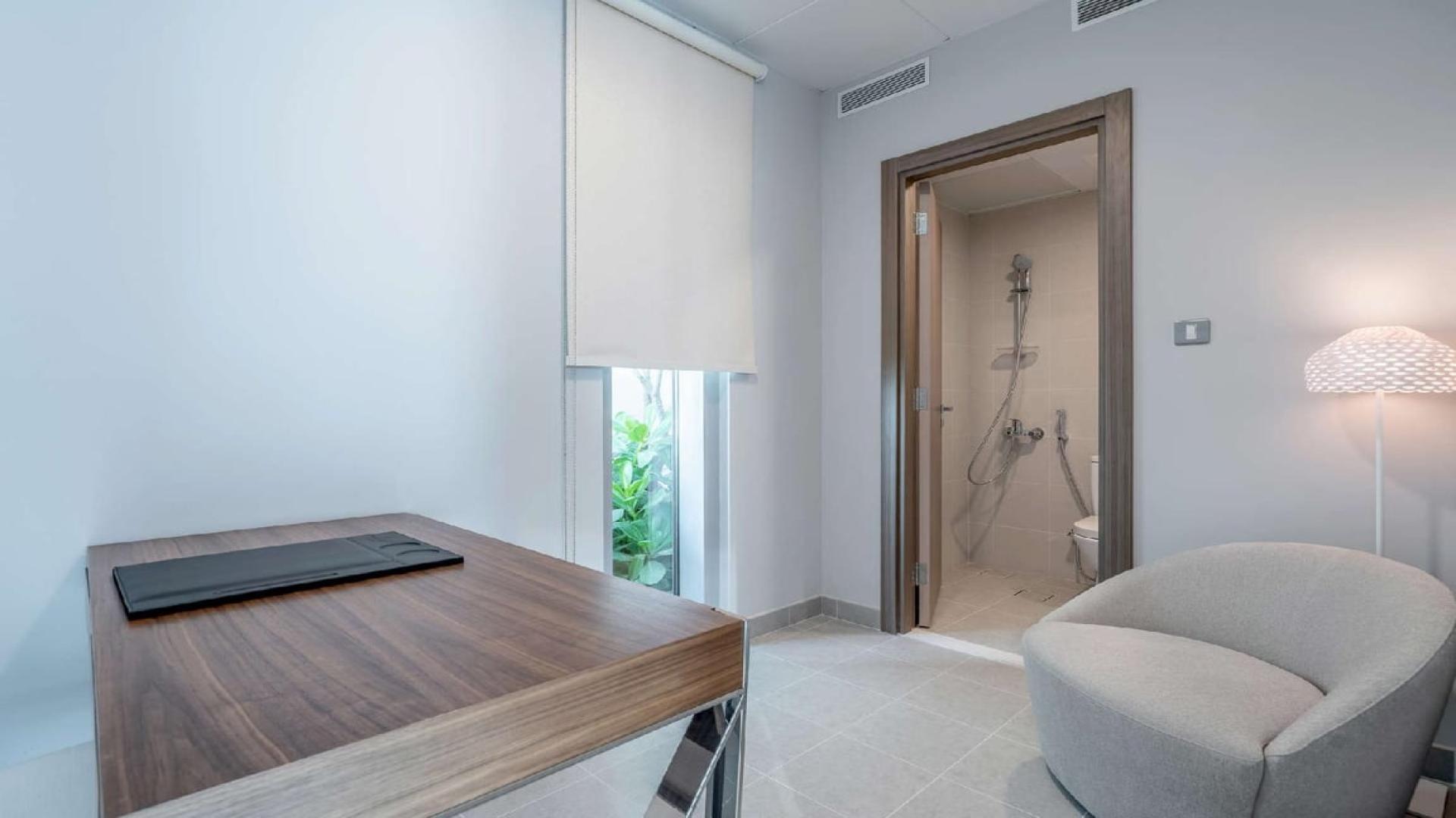 Bright living room in District One apartment, featuring modern decor and large windows