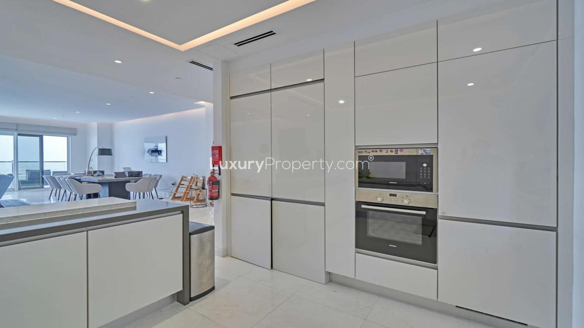 Luxurious JBR apartment living room with panoramic Arabian Gulf views, modern decor, spacious layout