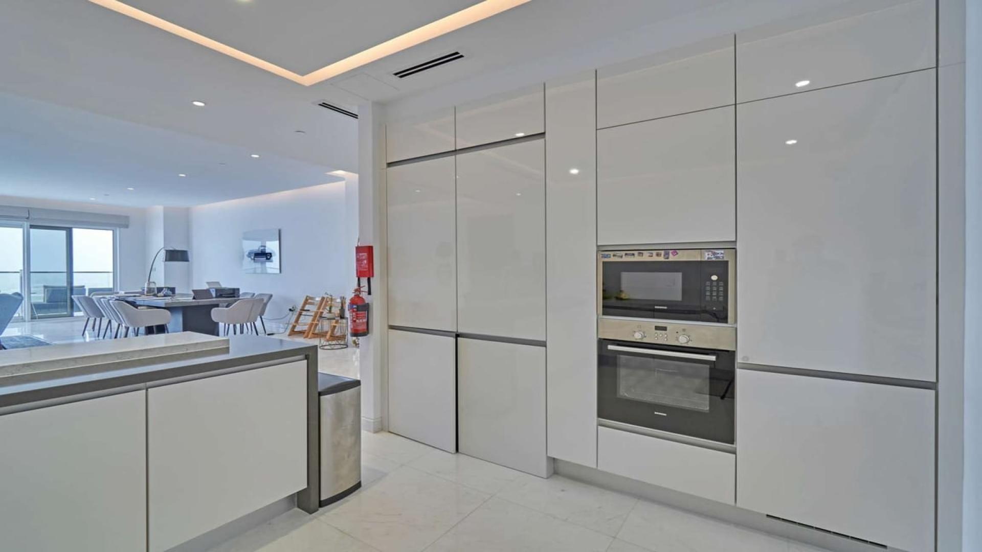 Luxurious JBR apartment living room with panoramic Arabian Gulf views, modern decor, spacious layout