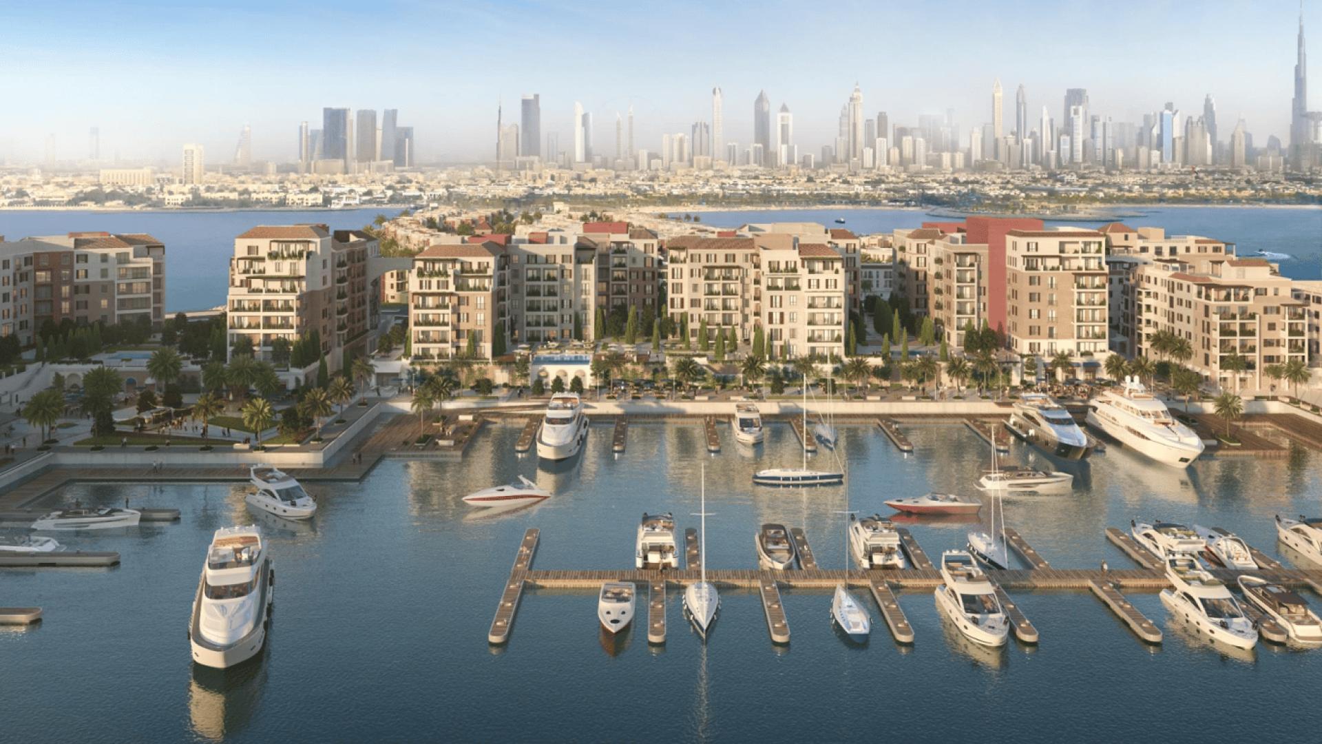 Marina view of Le Ciel at Port de La Mer apartments with yachts and skyline backdrop