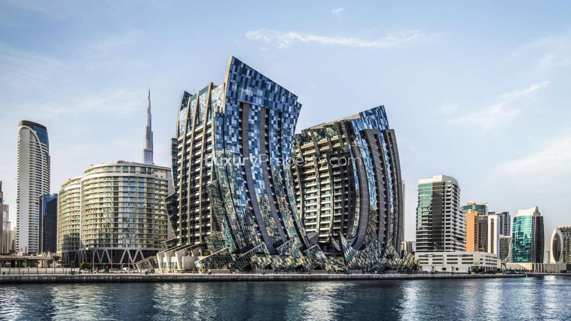 Da Vinci Tower in Business Bay at dusk, reflecting on water, modern architecture