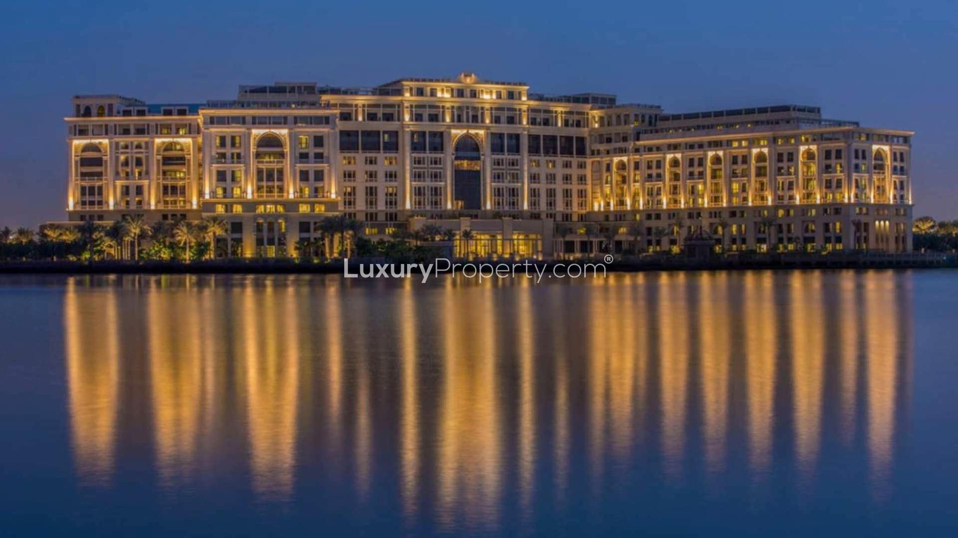 Night view of Palazzo Versace Hotel exterior reflecting on water, Culture Village