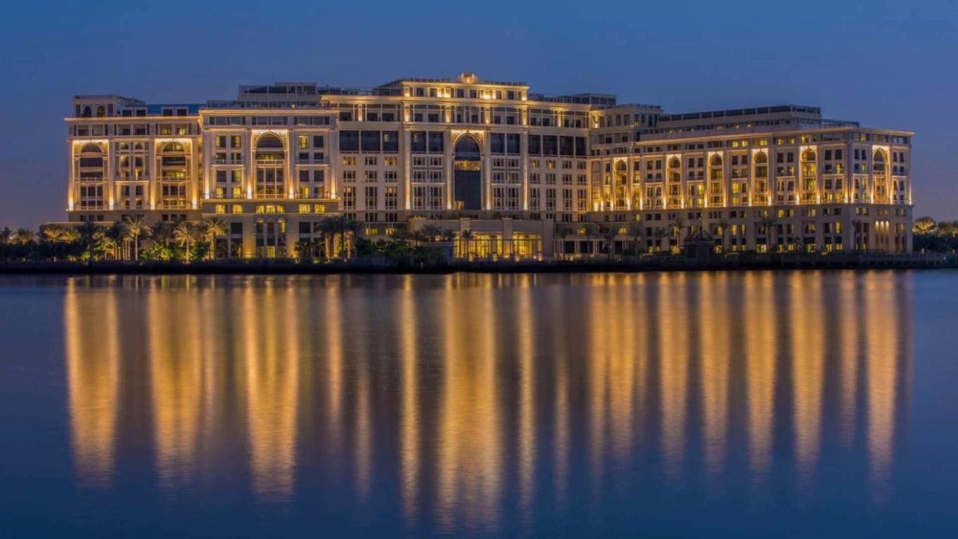 Night view of Palazzo Versace Hotel exterior reflecting on water, Culture Village