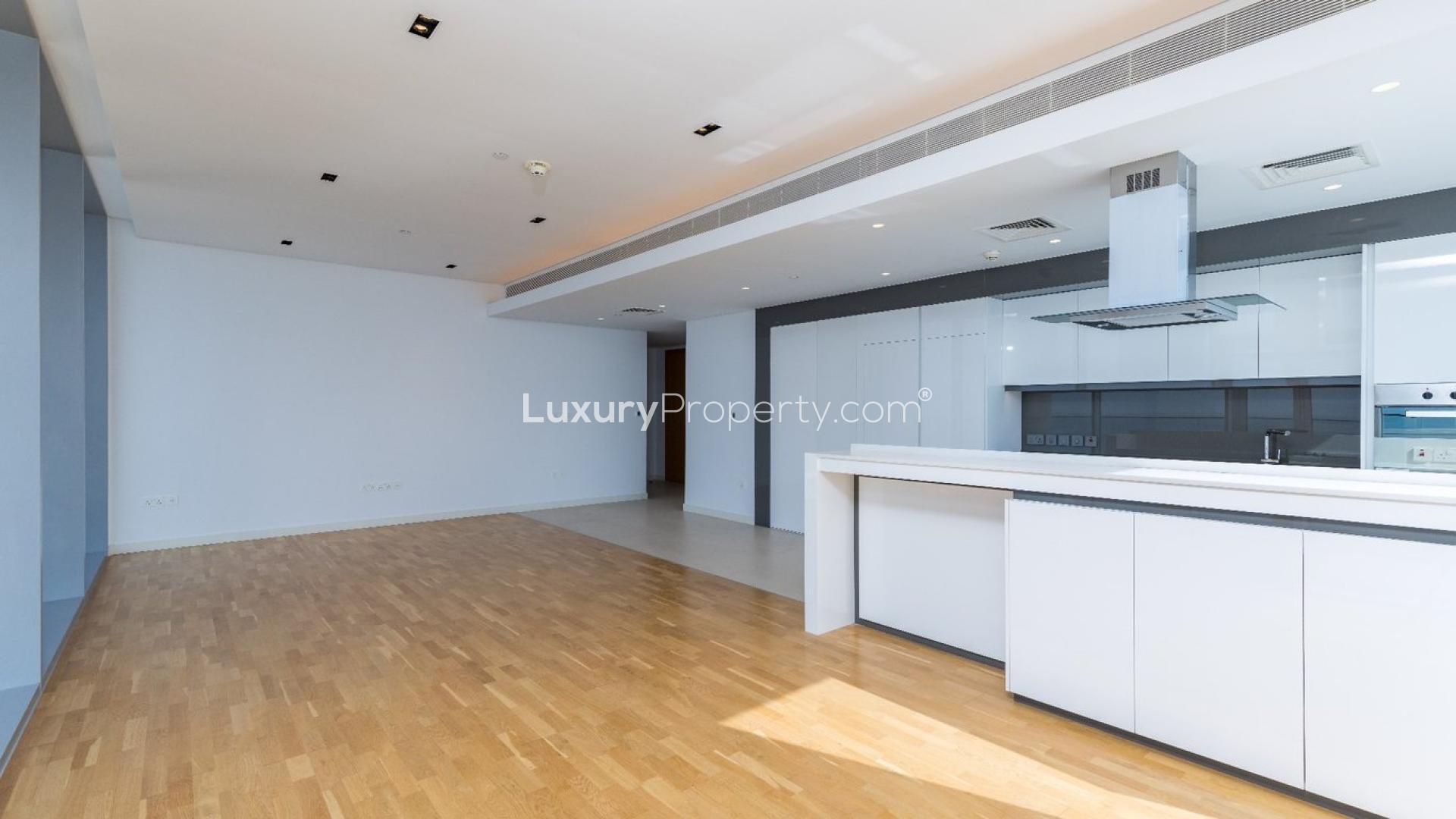 Spacious Bluewaters apartment living area with sea view, modern kitchen, natural light