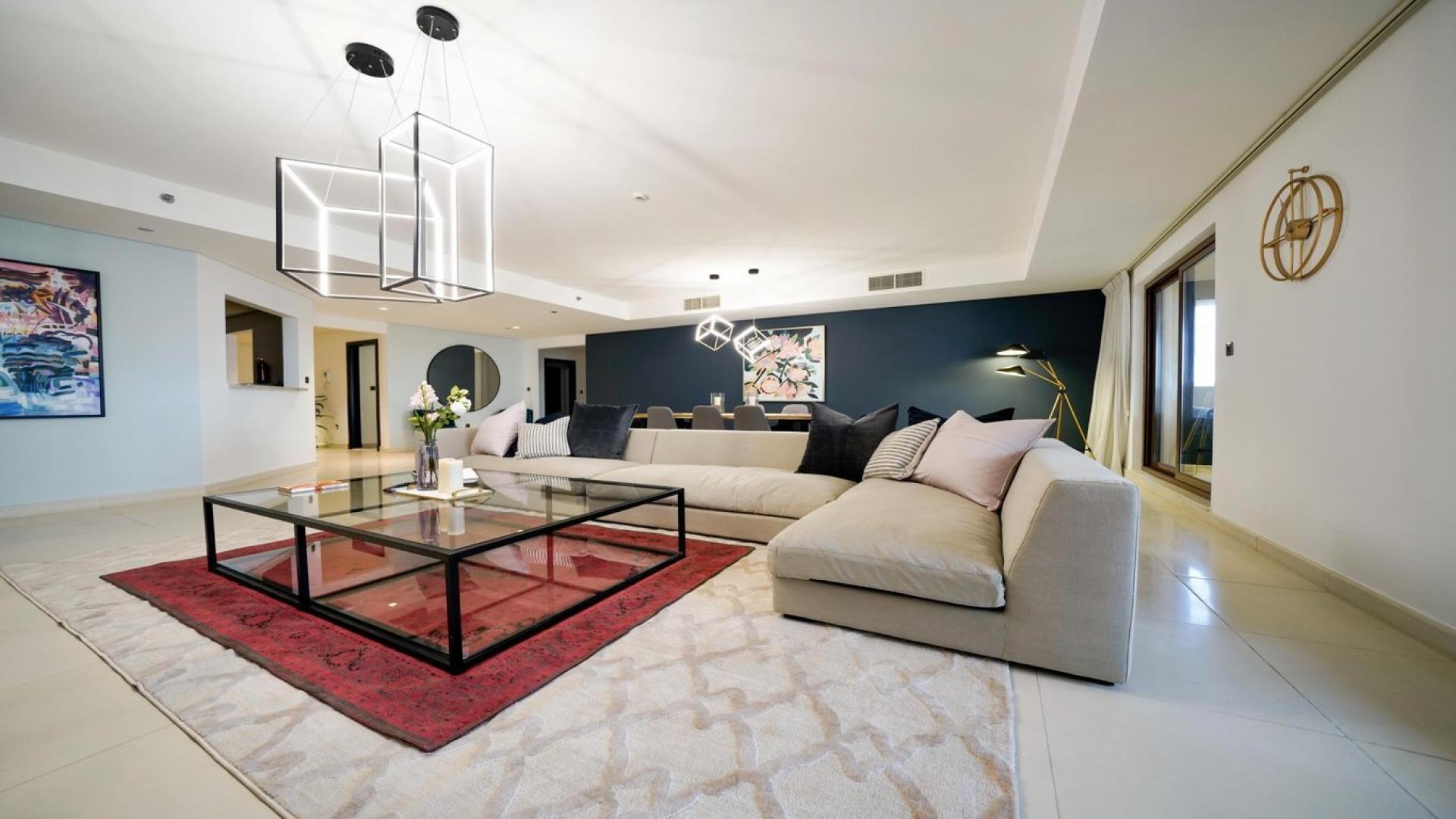 "Scenic sea view from Palm Jumeirah apartment, Kingdom of Sheba, Dubai skyline in background.",Modern living room in Palm Jumeirah apartment, featuring stylish decor and spacious seating area
