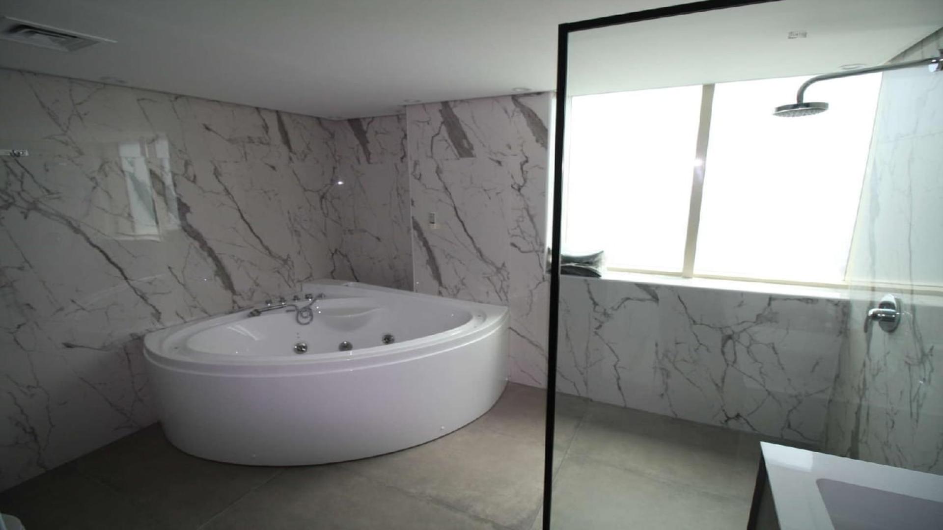 Dining area in luxury 4-bedroom penthouse, Dubai Marina, with elegant table and chairs