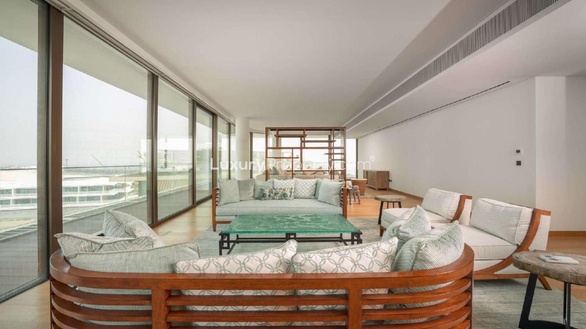 "Luxurious waterfront penthouse living room with stunning sea views, Bulgari Residences Dubai.",Luxurious living room in waterfront penthouse, Bulgari Residences, Jumeirah Bay Island, Dubai