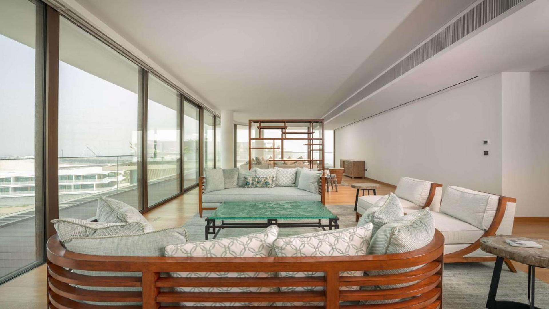 "Luxurious waterfront penthouse living room with stunning sea views, Bulgari Residences Dubai.",Luxurious living room in waterfront penthouse, Bulgari Residences, Jumeirah Bay Island, Dubai