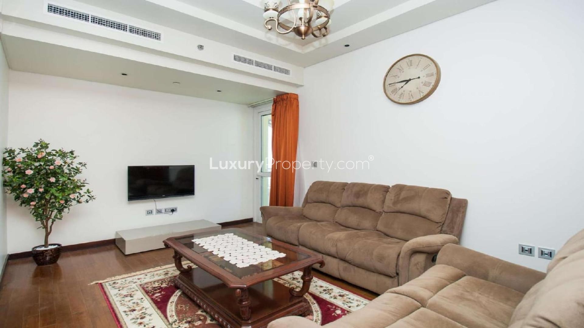 Luxurious living room in Marina Residences penthouse, Palm Jumeirah, with modern furnishings and staircase