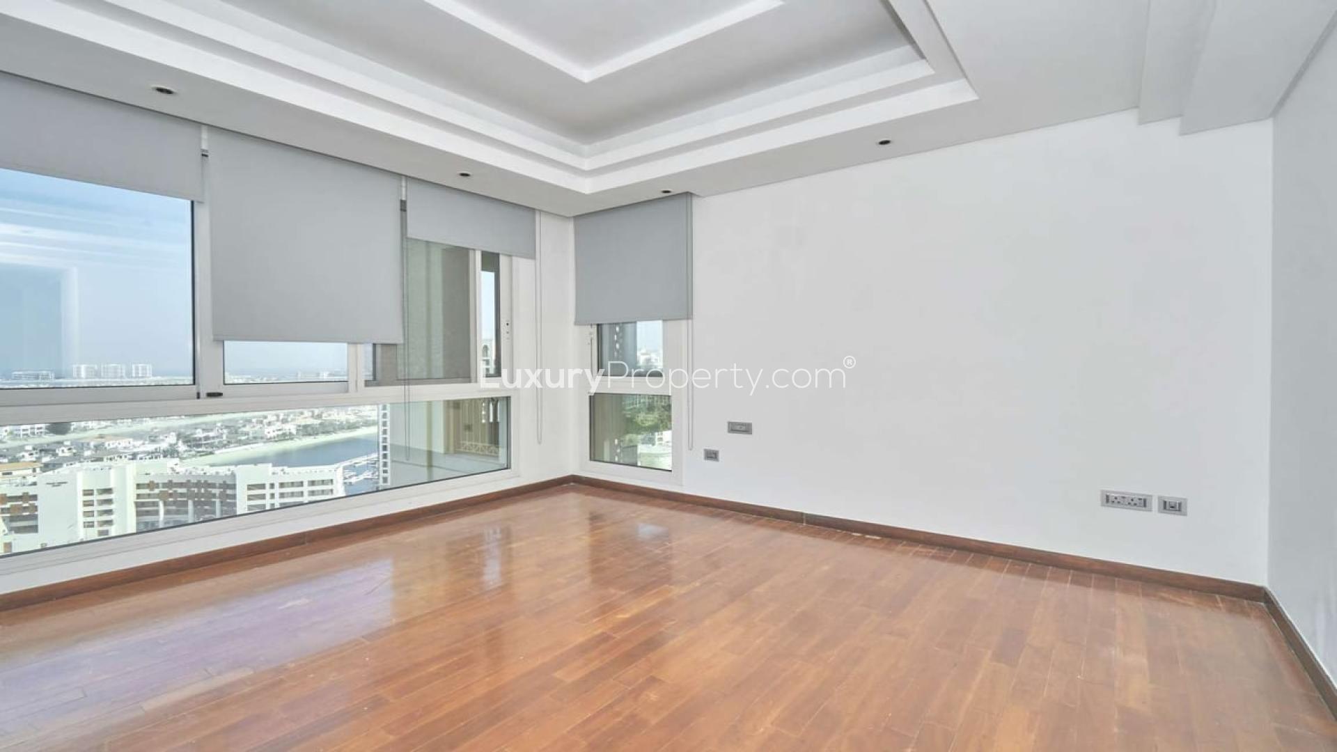 Spacious living area with large windows in Palm Jumeirah penthouse, Marina Residences