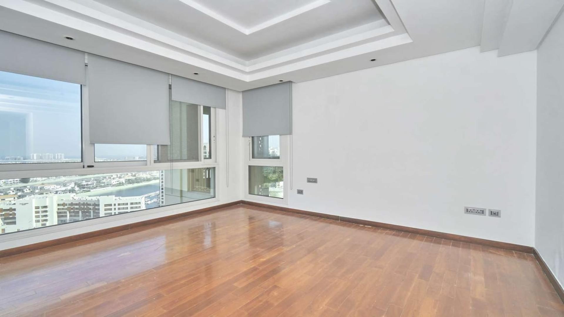 Spacious living area with large windows in Palm Jumeirah penthouse, Marina Residences