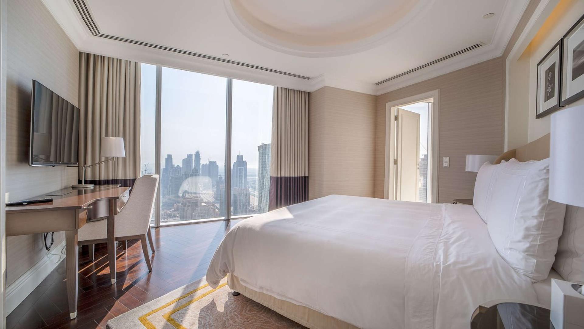 "Balcony view of Burj Khalifa from luxury apartment at The Address The BLVD, Downtown Dubai.",Luxurious bedroom with city view in 3-bedroom apartment, The Address - The Boulevard, Dubai