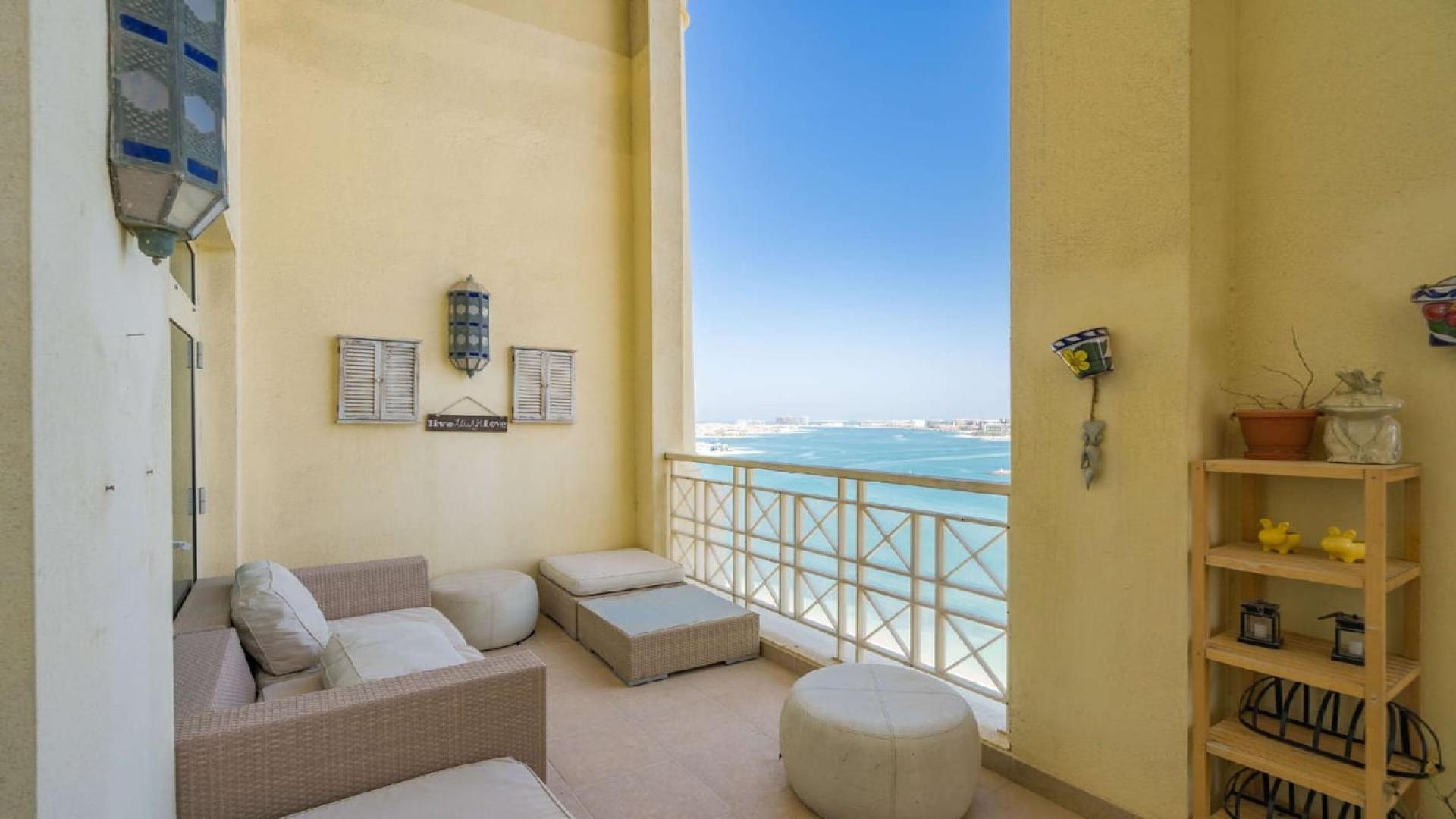Luxurious living room in Palm Jumeirah penthouse with elegant staircase and modern decor