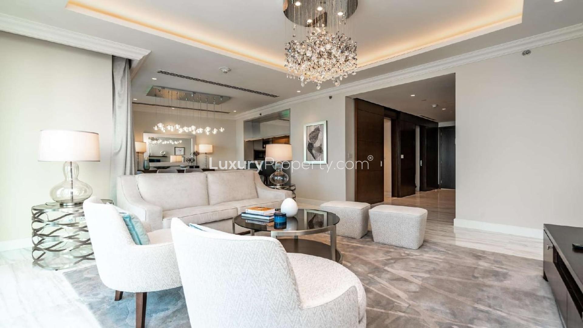 Luxurious living room in four-bed penthouse, Downtown Dubai, with elegant chandelier and modern decor