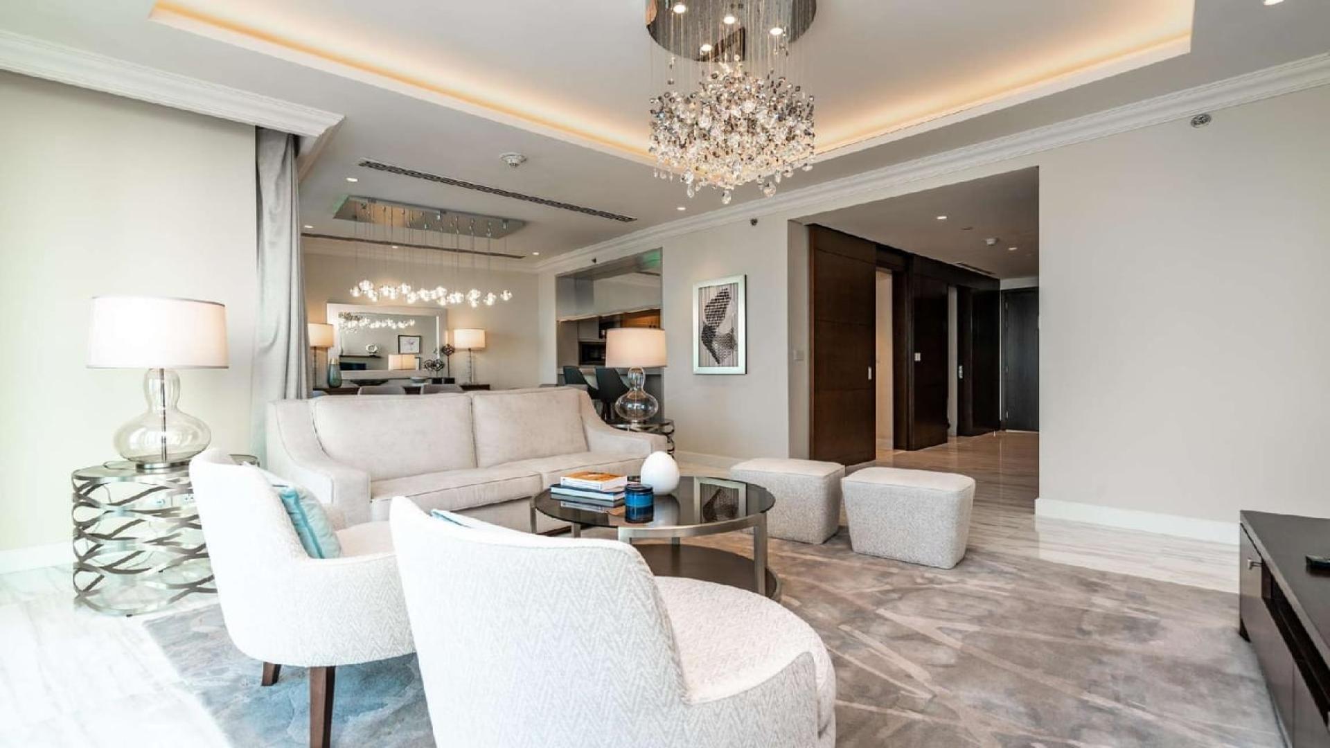 Luxurious living room in four-bed penthouse, Downtown Dubai, with elegant chandelier and modern decor