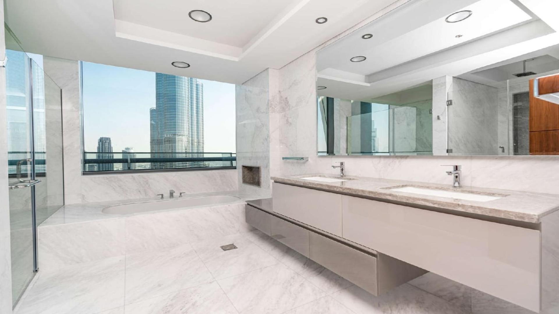 Bright living area with floor-to-ceiling windows in Burj Vista penthouse, Downtown Dubai