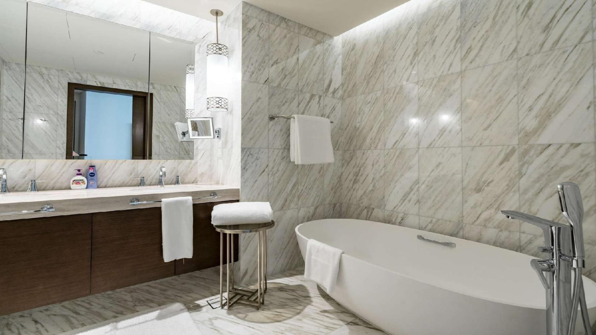 Luxurious living room in Downtown Dubai penthouse with stunning city views, modern decor