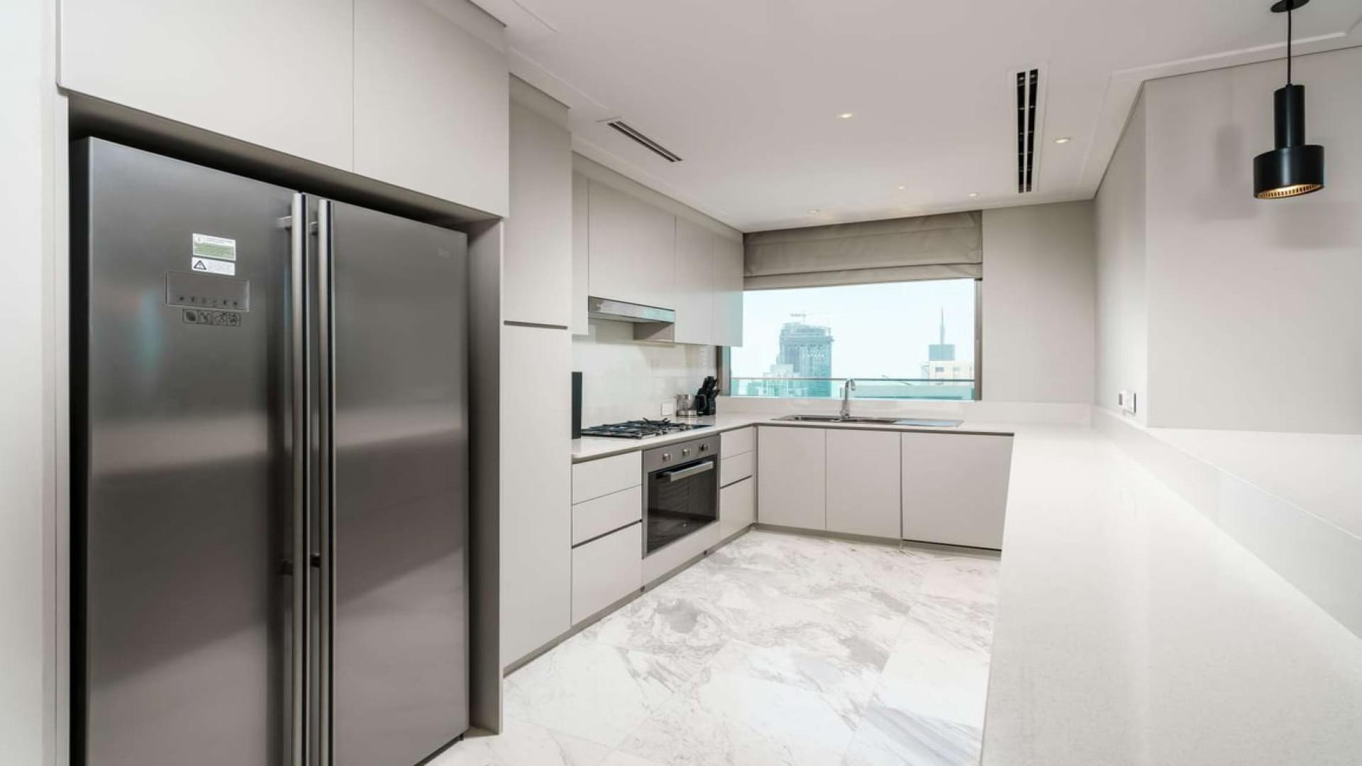 Luxurious living room in Vida Residences penthouse, Downtown Dubai, with city skyline views