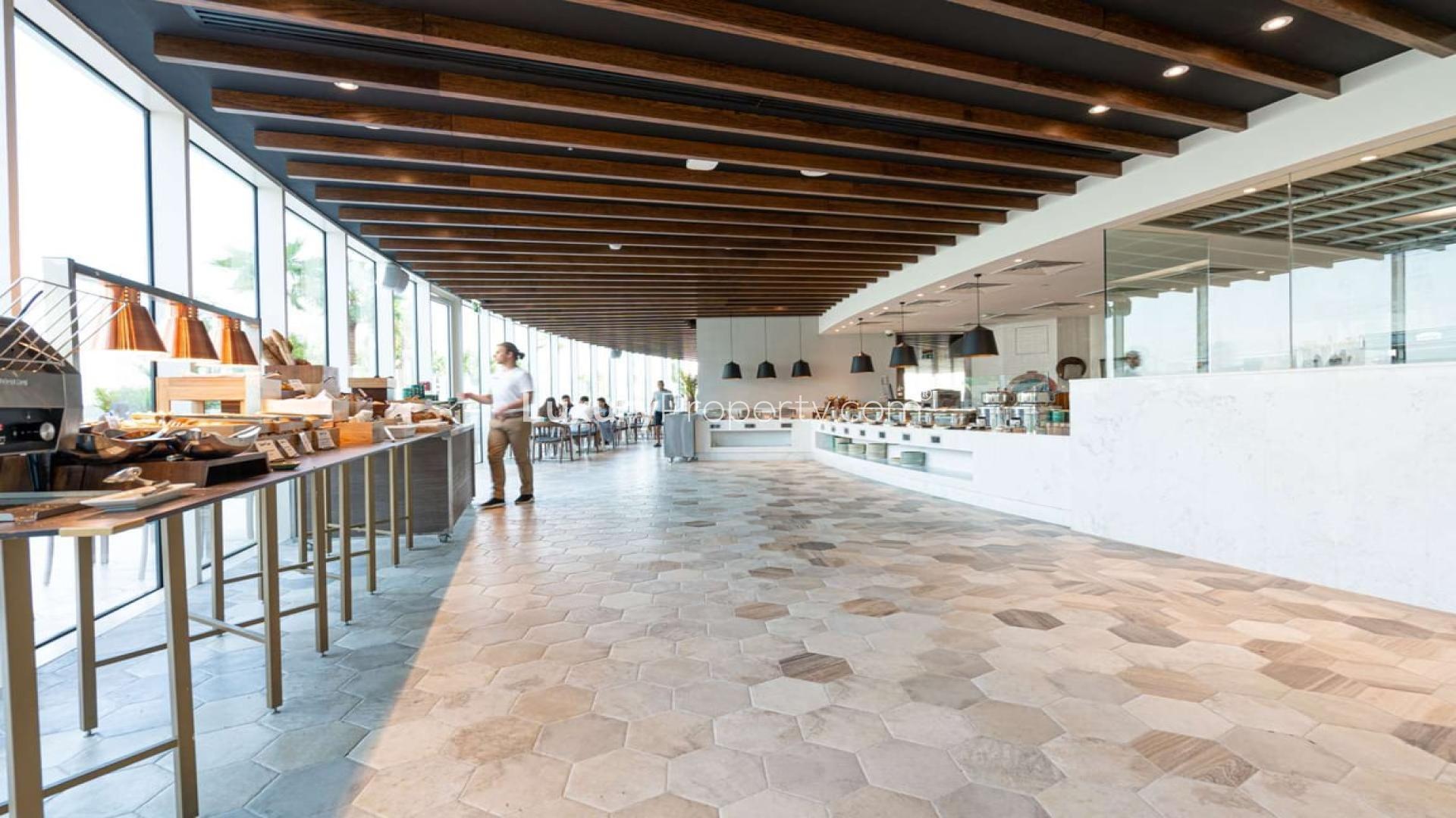 Modern living room in 4-bedroom penthouse, JVC, with pool view and elegant decor