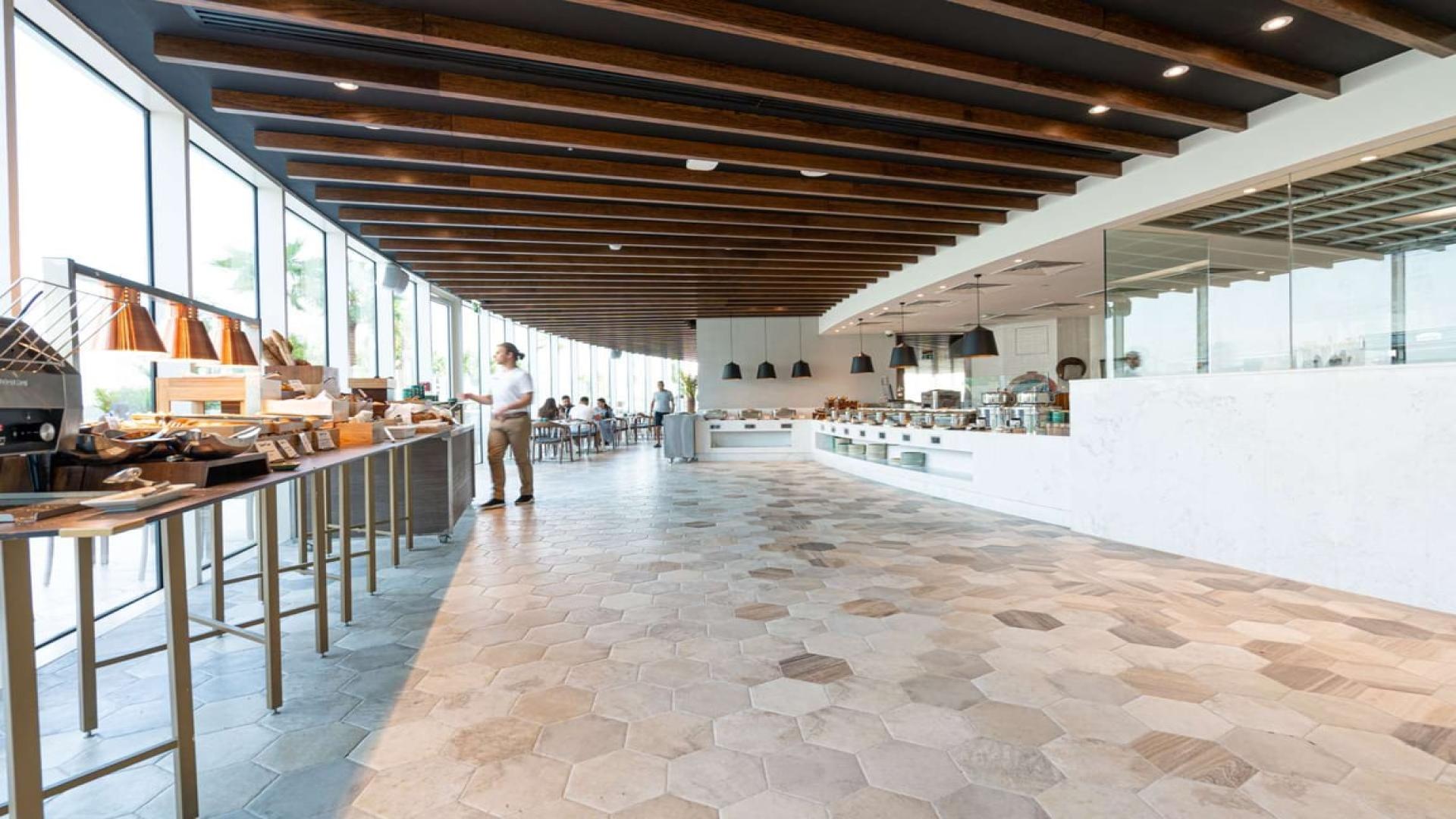 Modern living room in 4-bedroom penthouse, JVC, with pool view and elegant decor