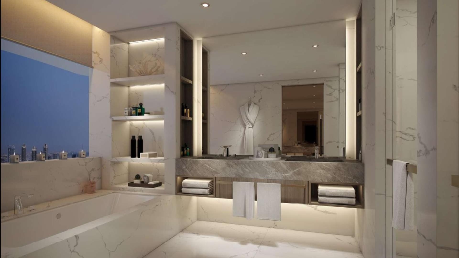 Luxurious bathroom in IL Primo Downtown penthouse, featuring marble finishes and elegant lighting