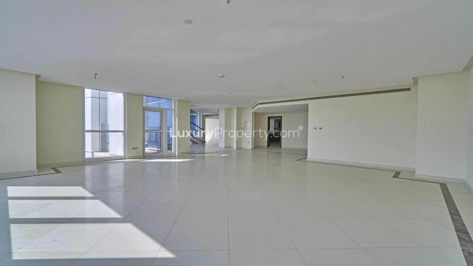 "Spacious high-floor duplex penthouse living area with city views in 23 Marina, Dubai.",High-floor duplex penthouse interior with spacious living area, 23 Marina, Dubai Marina