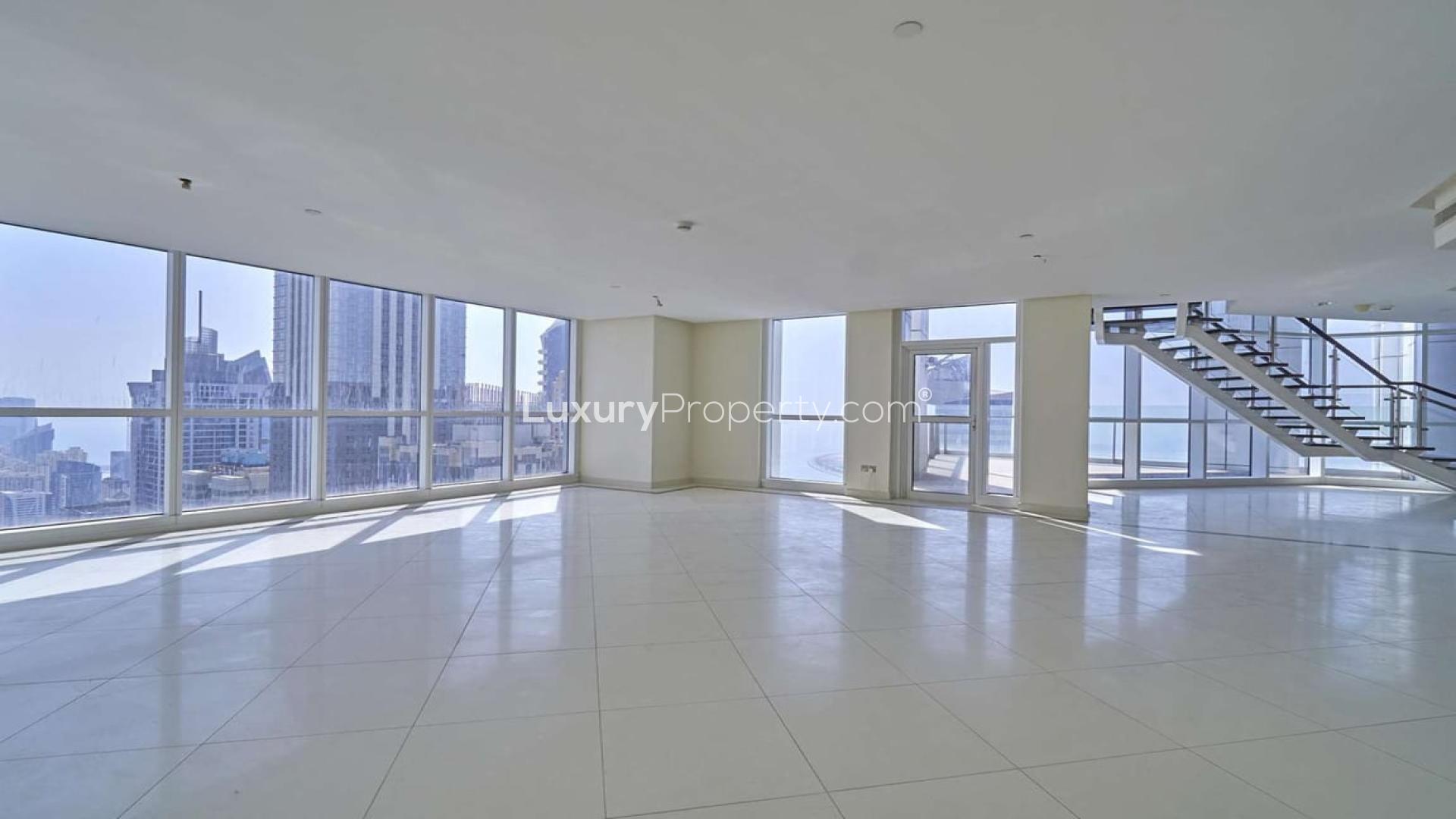 High-floor duplex penthouse staircase with glass railing in 23 Marina, Dubai Marina