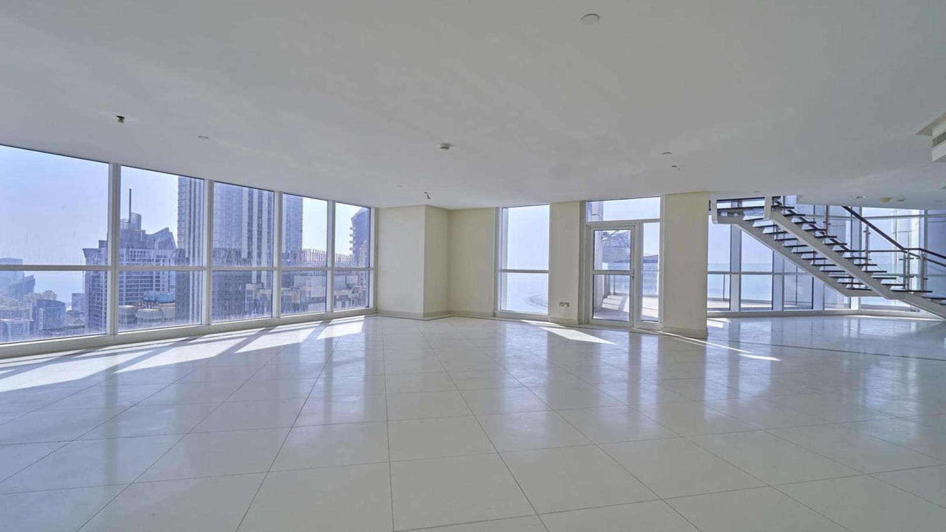 High-floor duplex penthouse staircase with glass railing in 23 Marina, Dubai Marina
