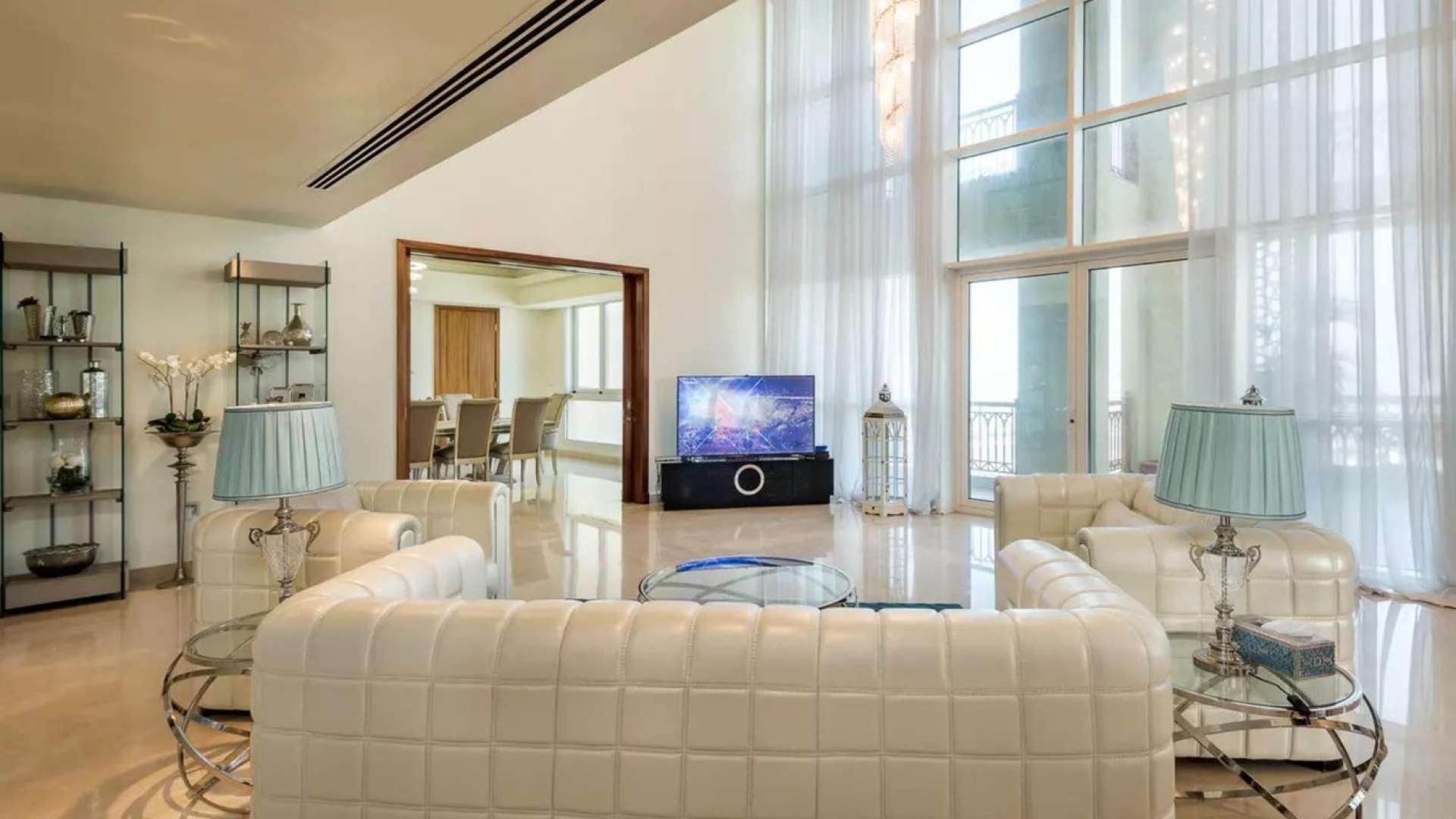 Luxurious living room in Palm Jumeirah penthouse with modern decor and large windows
