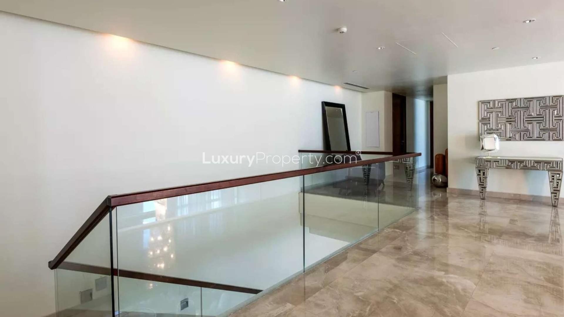 "Stunning Palm Jumeirah marina view from luxury penthouse in Marina Residences, Dubai.",Luxurious hallway in duplex penthouse at Marina Residences, Palm Jumeirah, for sale