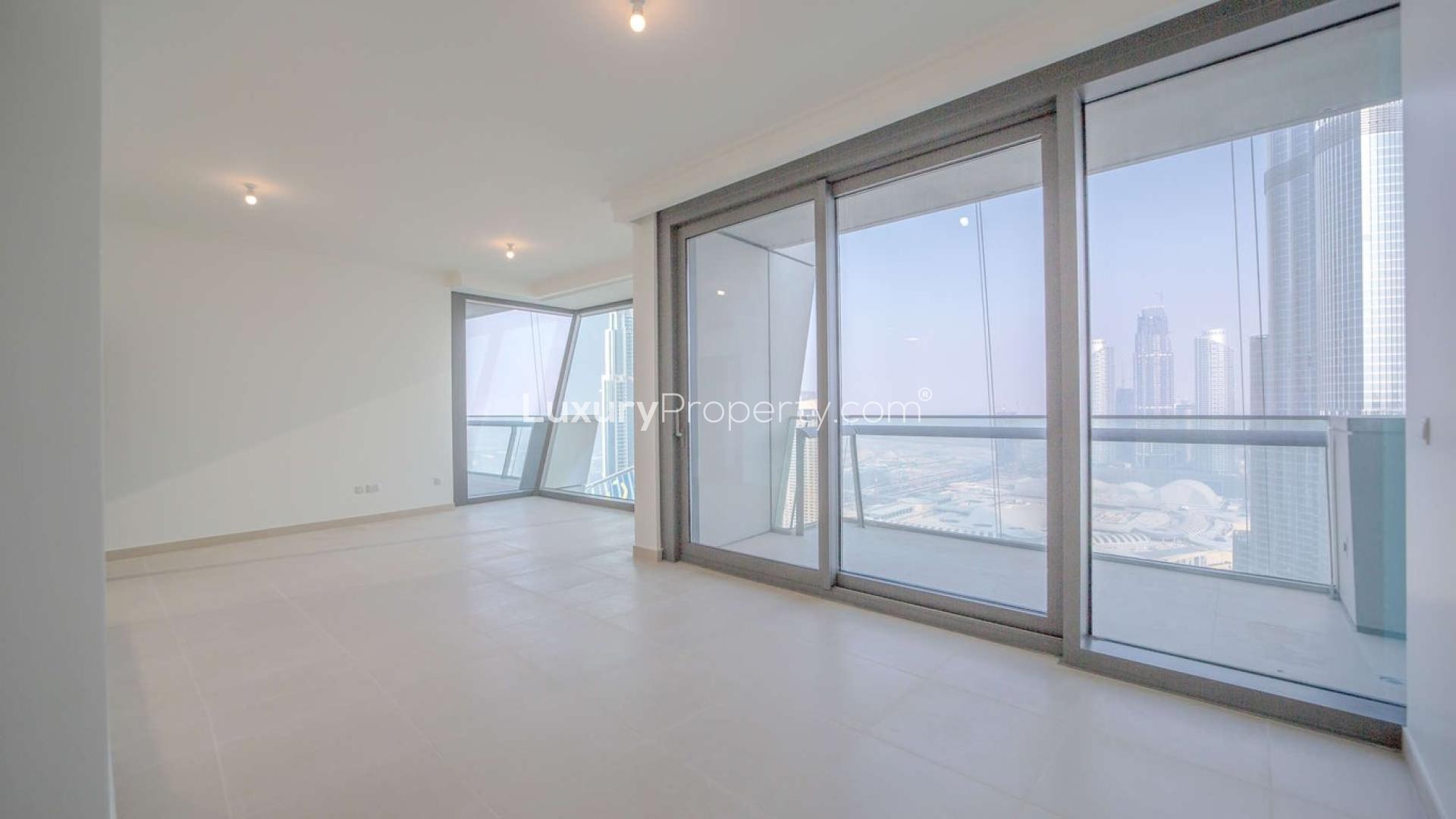 Bright living room with floor-to-ceiling windows in Burj Vista apartment, Downtown Dubai