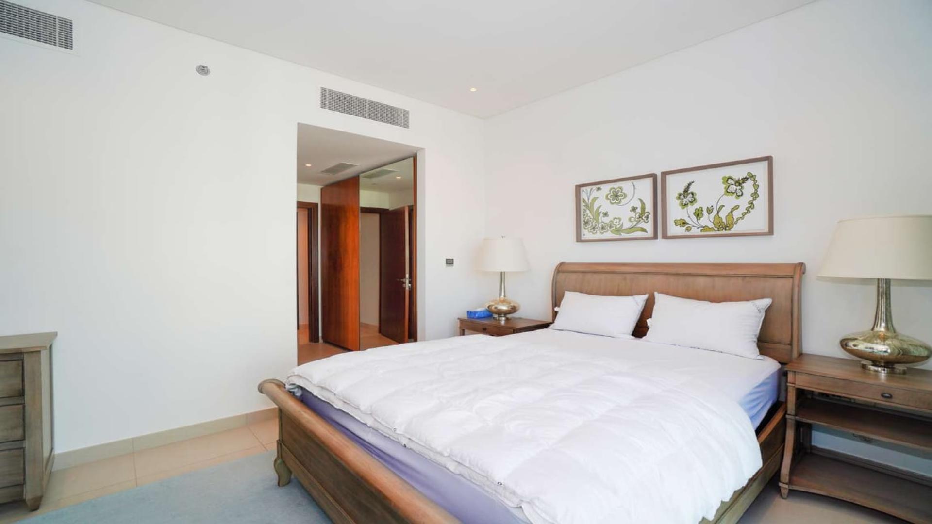 Luxurious living room in Marina Gate penthouse, featuring modern decor and elegant staircase