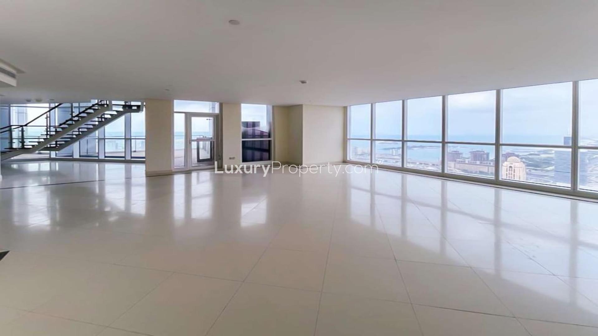 Interior of Dubai Marina penthouse with floor-to-ceiling windows and stunning city views