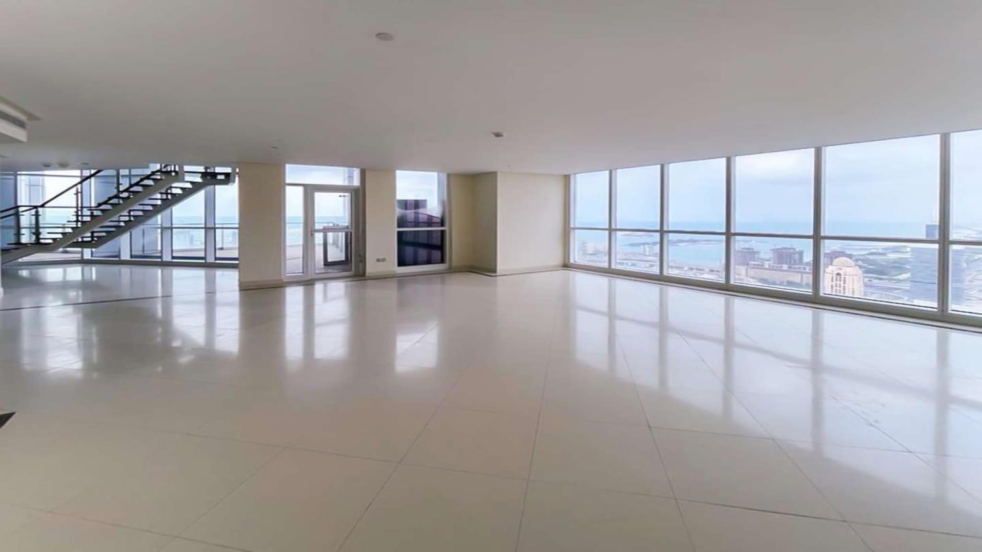 Interior of Dubai Marina penthouse with floor-to-ceiling windows and stunning city views