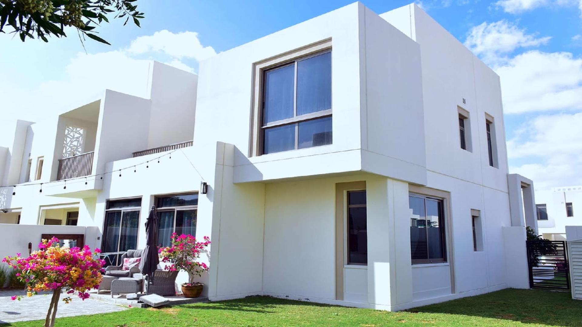 Modern 4-bedroom Zahra Townhouse exterior with garden in Town Square for rent