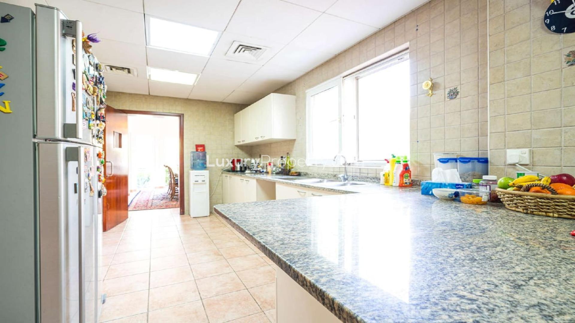 Luxurious living room in 4-bedroom townhouse, Green Community East, with elegant decor and garden view