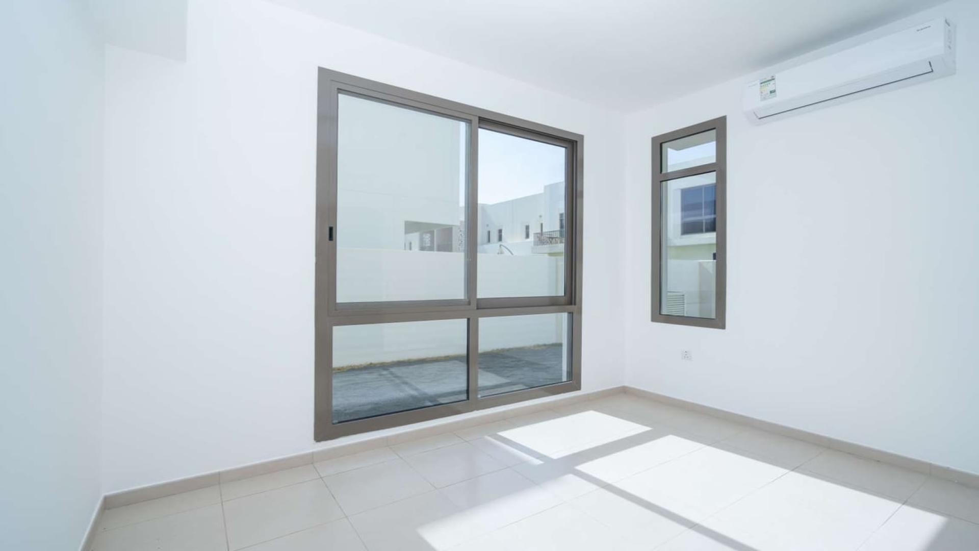 Outdoor pool area at Hayat Townhouses, Town Square, surrounded by greenery and seating