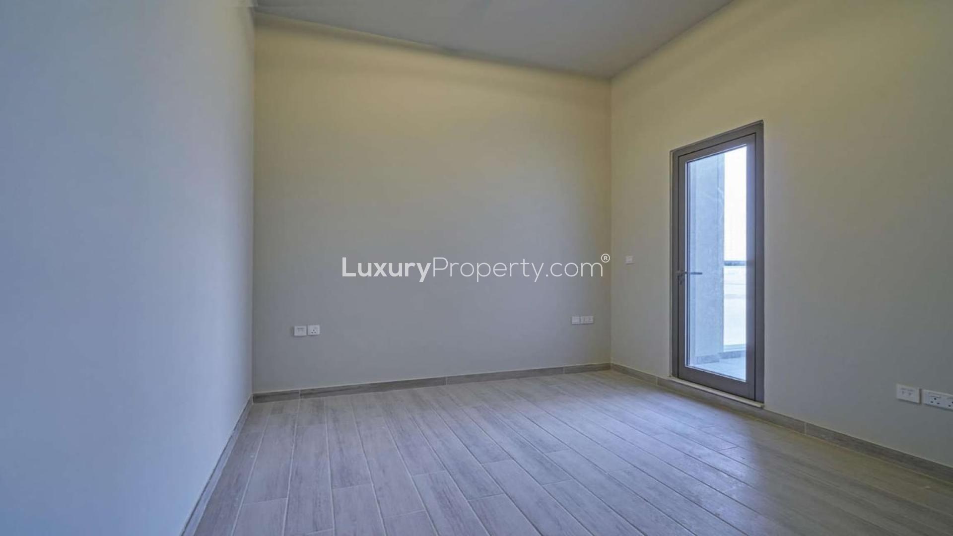 Modern townhouse exterior in Al Furjan, Murano Residences, featuring spacious driveway and entrance