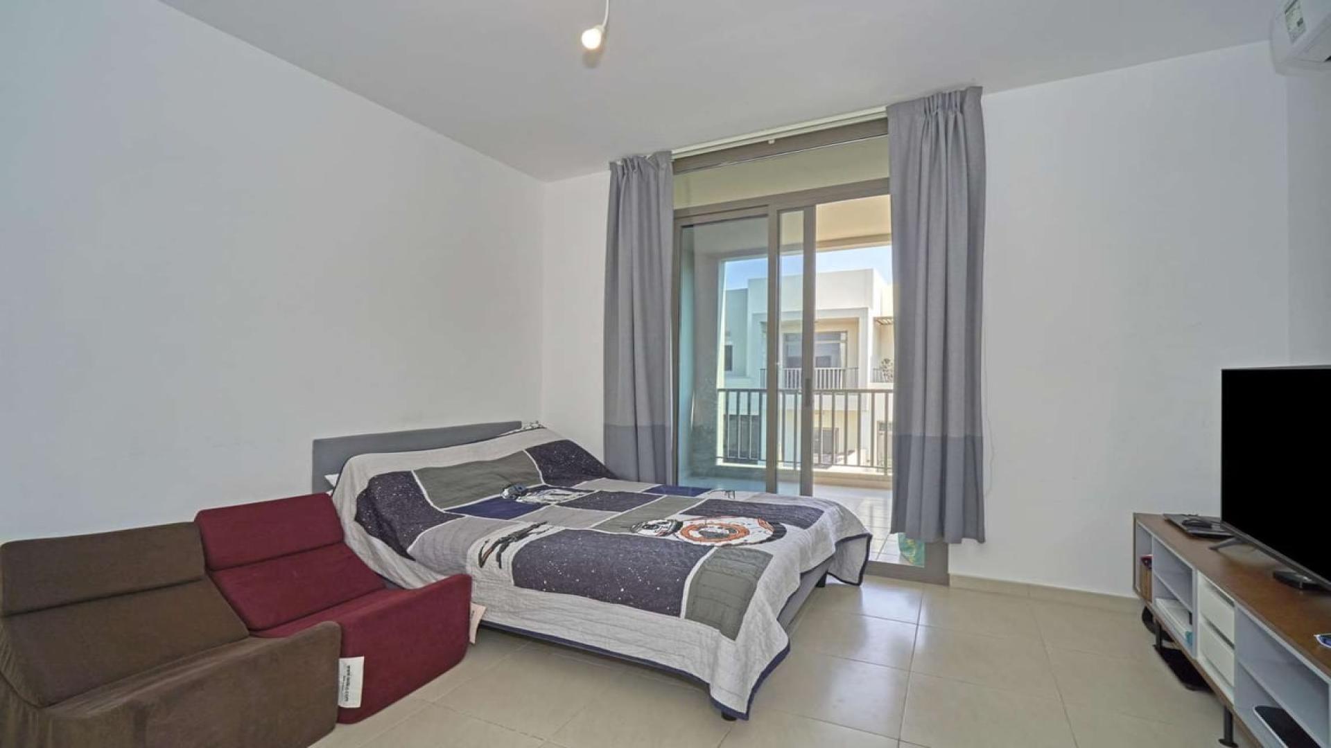 Living room in Hayat townhouse, Town Square, featuring modern decor and dining area