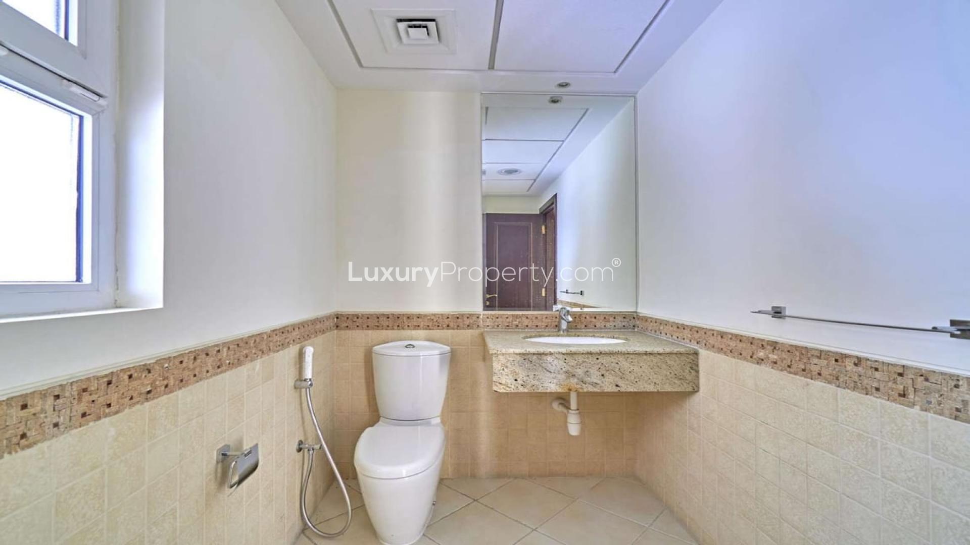 "Spacious Layan Community townhouse exterior with garden, Dubai, available for rent.",Modern bathroom in spacious 4-bedroom townhouse, Layan Community, Dubai, available for rent