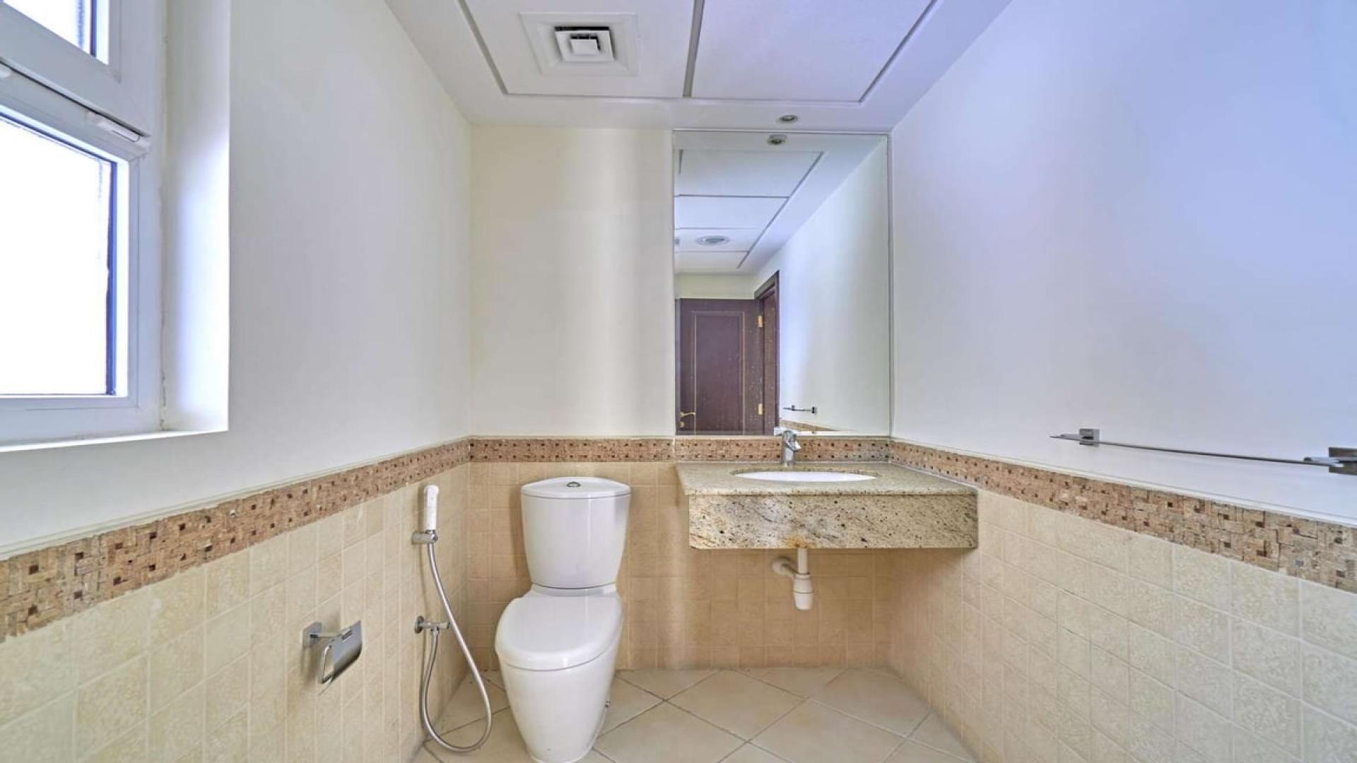 "Spacious Layan Community townhouse exterior with garden, Dubai, available for rent.",Modern bathroom in spacious 4-bedroom townhouse, Layan Community, Dubai, available for rent