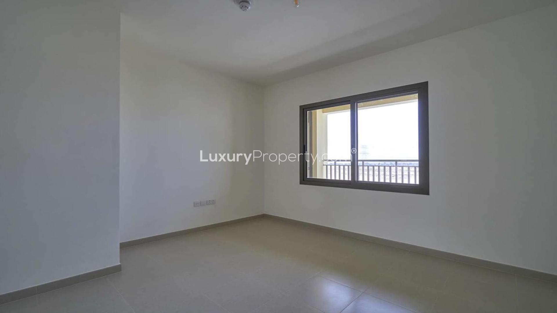 "Modern 4-bedroom townhouse exterior in Naseem, Town Square, available for rent.",Empty bedroom with large window in 4-bedroom townhouse, Naseem Townhouses, Town Square