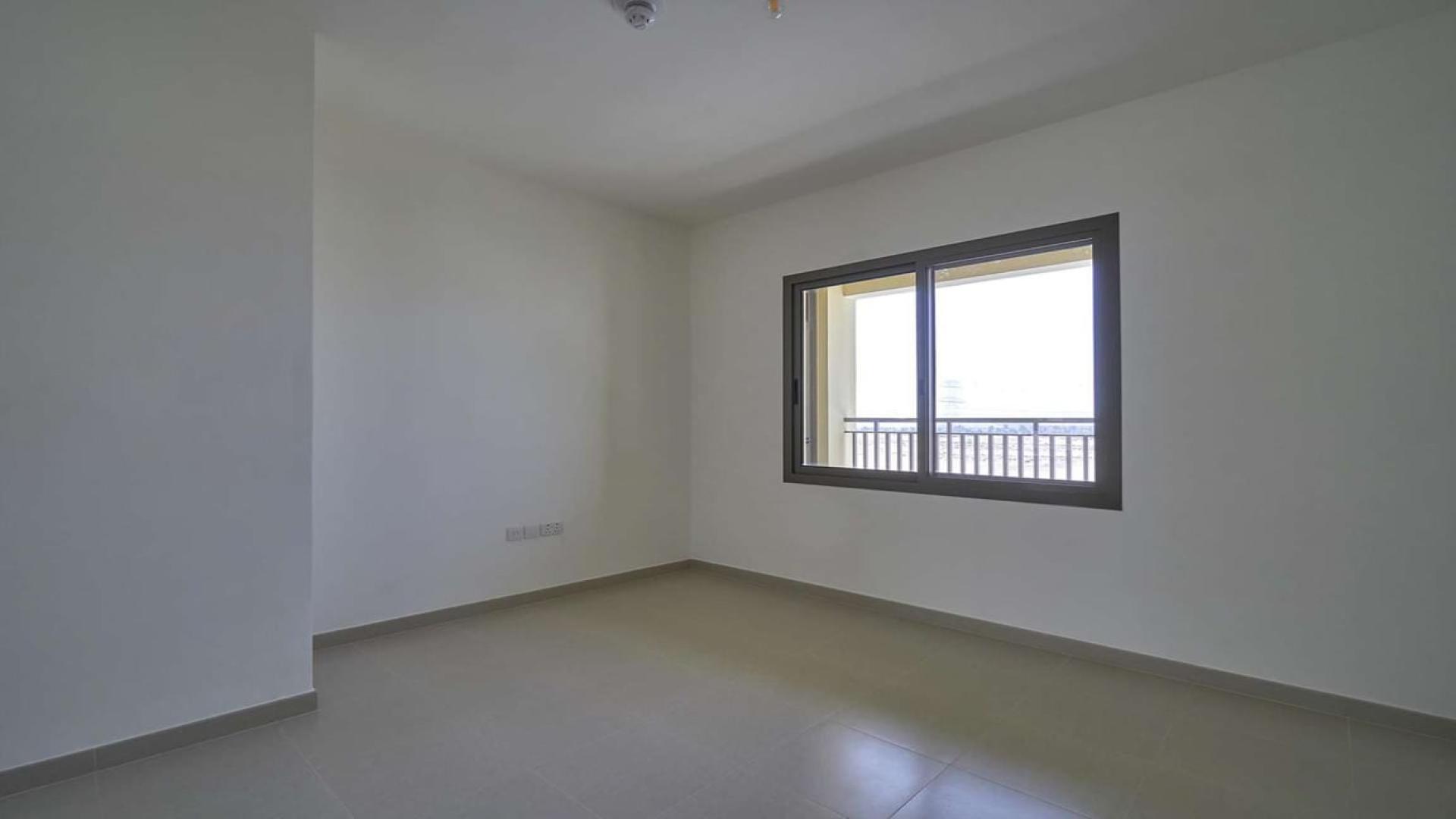 "Modern 4-bedroom townhouse exterior in Naseem, Town Square, available for rent.",Empty bedroom with large window in 4-bedroom townhouse, Naseem Townhouses, Town Square