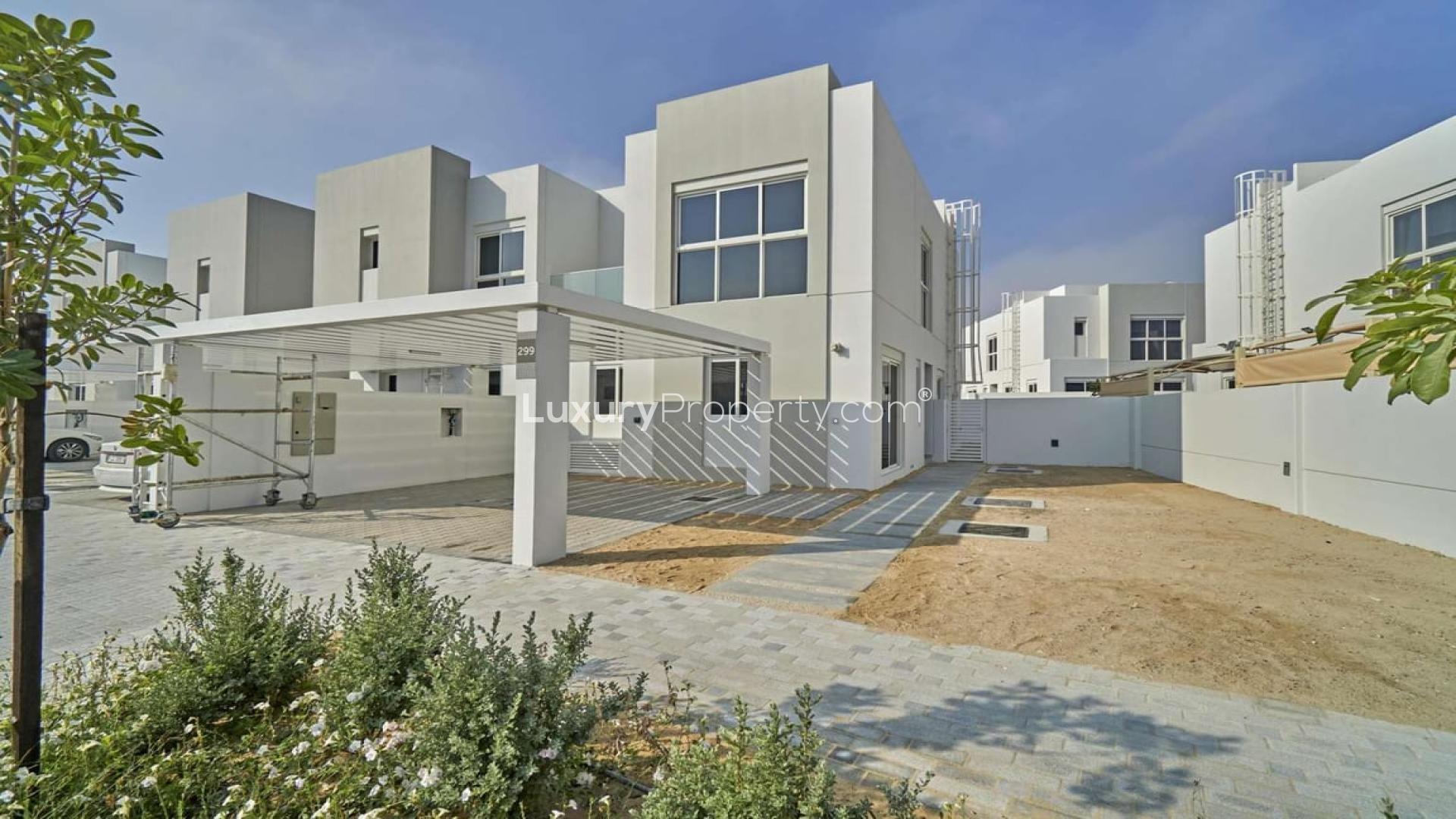 Spacious 4-bedroom townhouse exterior in Arabella 3, Mudon, with garden and carport